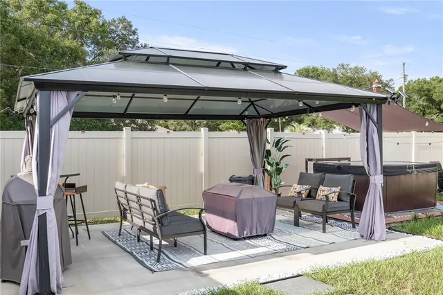 a view of patio with table and chairs under an umbrella