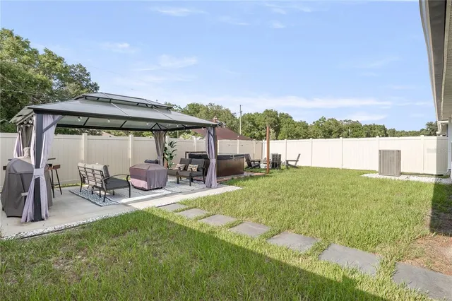 a view of a patio with table and chairs under an umbrella