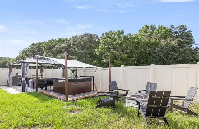 a view of a patio with chairs and plants