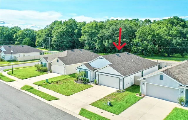 an aerial view of a house with yard