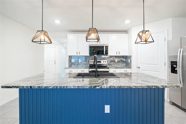 a kitchen with a refrigerator a sink and a stove