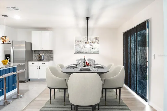 a dining room with furniture a chandelier and window