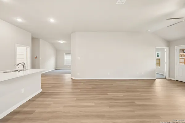 a view of large kitchen with wooden floor and a sink