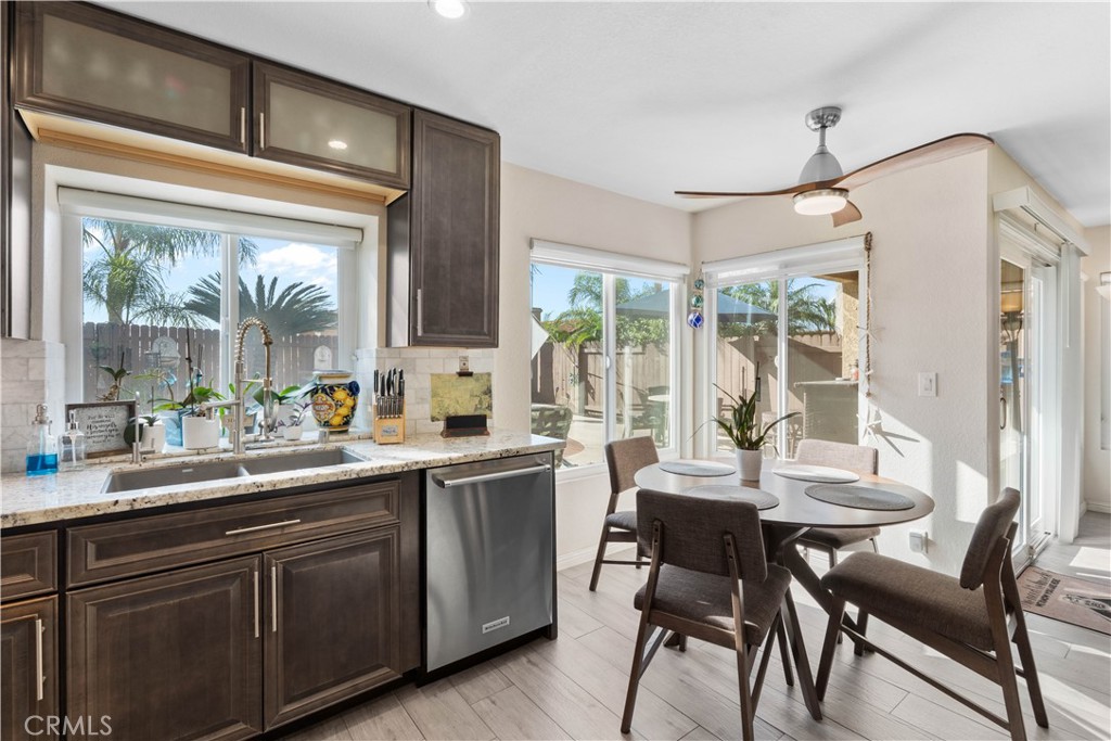 10963 San Mateo Place Rancho Cucamonga, CA 91701 - Photo 12 of 37 a kitchen with a table chairs sink and cabinets