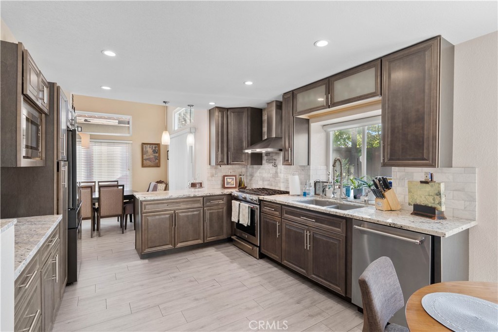 10963 San Mateo Place Rancho Cucamonga, CA 91701 - Photo 13 of 37 a kitchen with lots of counter top space and stainless steel appliances