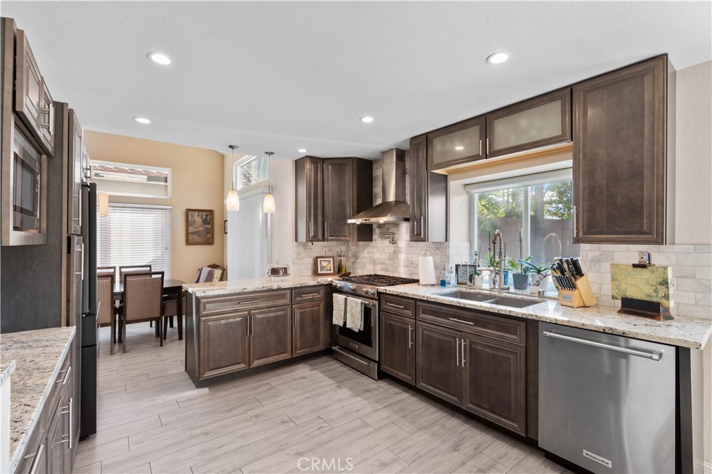 10963 San Mateo Place Rancho Cucamonga, CA 91701 - Photo 17 of 37 a kitchen with lots of counter top space sink and stainless steel appliances