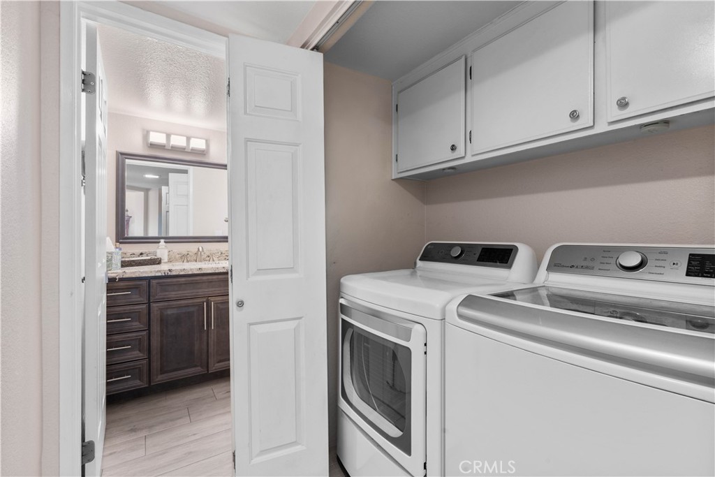 10963 San Mateo Place Rancho Cucamonga, CA 91701 - Photo 18 of 37 a view of washer and dryer with kitchen in the background