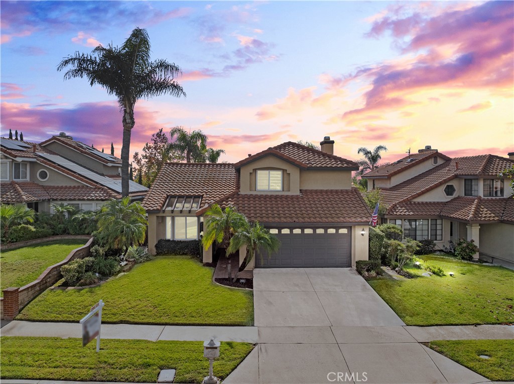 10963 San Mateo Place Rancho Cucamonga, CA 91701 - Photo 2 of 37 a front view of a house with a garden and plants