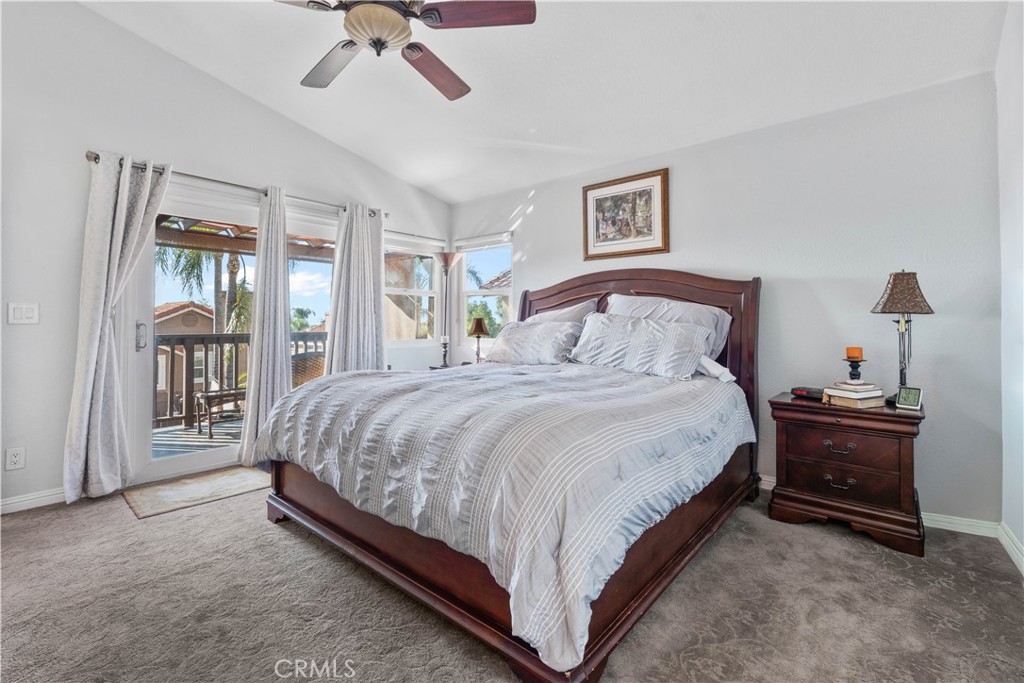 10963 San Mateo Place Rancho Cucamonga, CA 91701 - Photo 21 of 37 a spacious bedroom with a bed and a chandelier