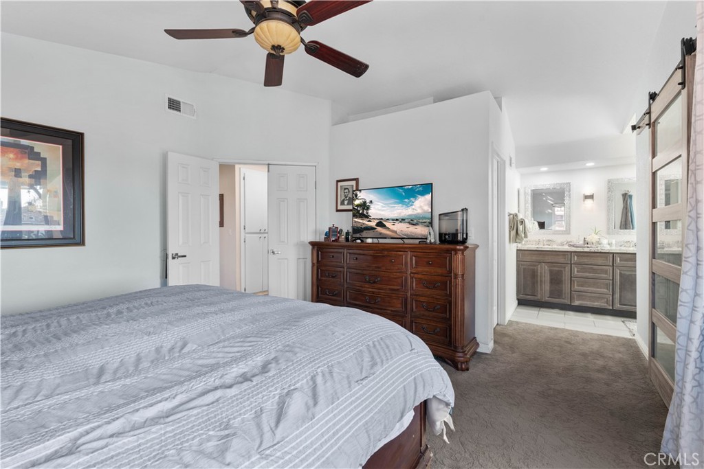 10963 San Mateo Place Rancho Cucamonga, CA 91701 - Photo 22 of 37 a bedroom with a bed and a view of kitchen