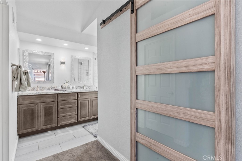 10963 San Mateo Place Rancho Cucamonga, CA 91701 - Photo 23 of 37 a bathroom with a sink and a mirror