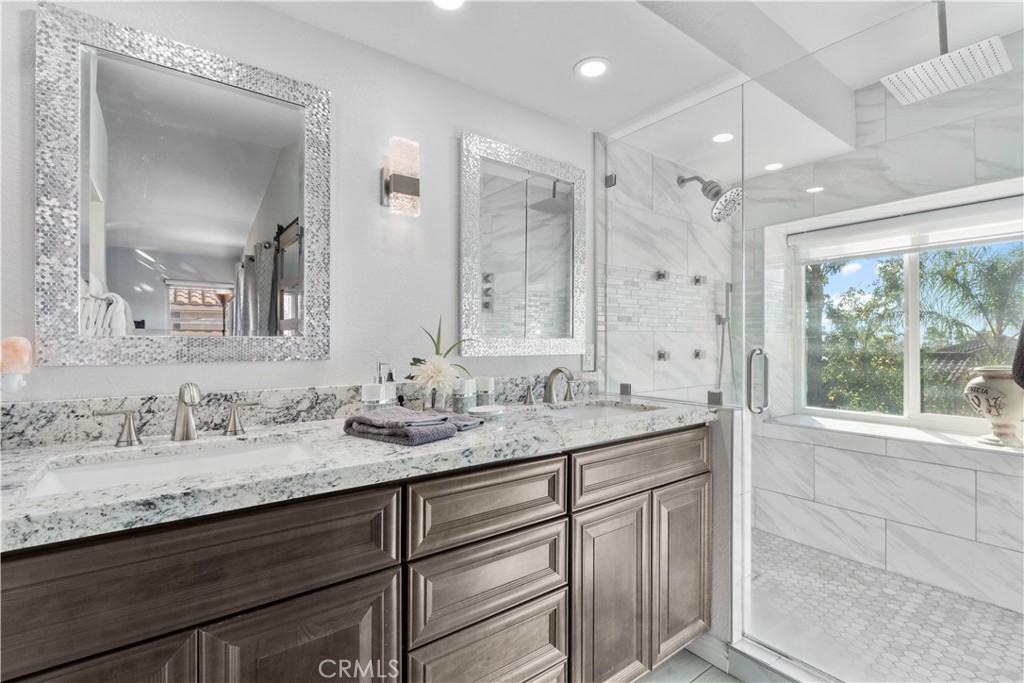 10963 San Mateo Place Rancho Cucamonga, CA 91701 - Photo 24 of 37 a bathroom with a granite countertop sink mirror and double