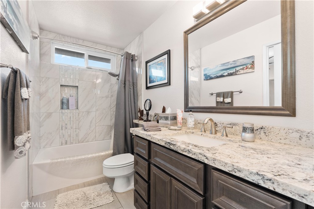 10963 San Mateo Place Rancho Cucamonga, CA 91701 - Photo 27 of 37 a bathroom with a granite countertop sink toilet and shower