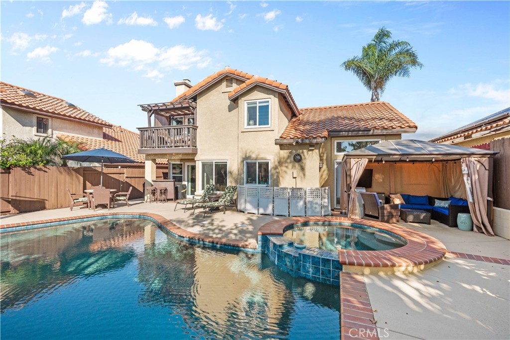 10963 San Mateo Place Rancho Cucamonga, CA 91701 - Photo 4 of 37 a front view of house with lake view and a sitting space