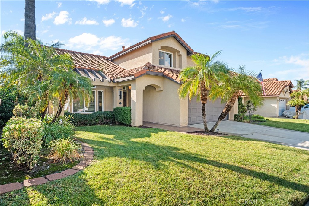 10963 San Mateo Place Rancho Cucamonga, CA 91701 - Photo 5 of 37 a front view of a house with a yard and garage