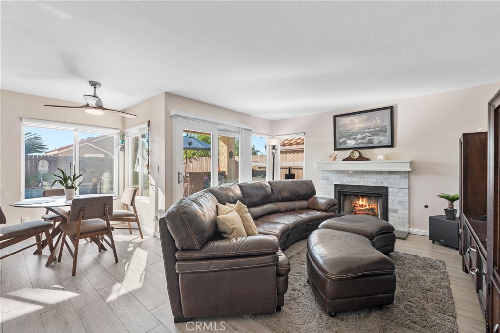 10963 San Mateo Place Rancho Cucamonga, CA 91701 - Photo 10 of 37 a living room with furniture a fireplace and a flat screen tv