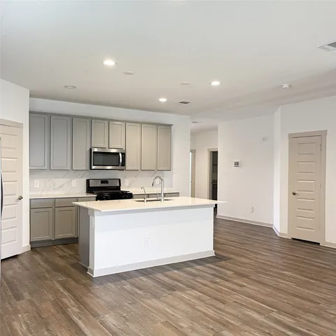 a kitchen with stainless steel appliances a sink and a refrigerator