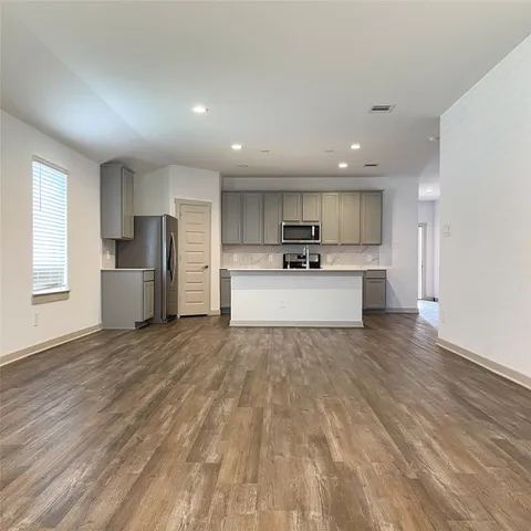 a kitchen with stainless steel appliances a refrigerator and a microwave