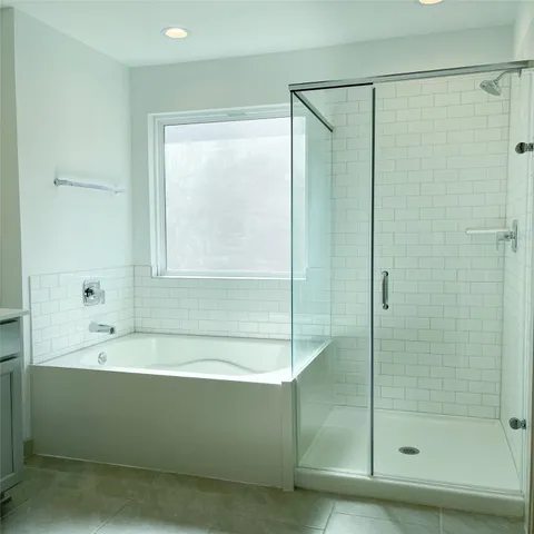a bathroom with a bathtub and a shower