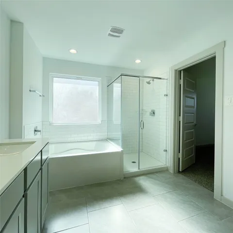 a spacious bathroom with a shower tub and a shower