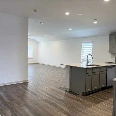 a view of a room with wooden floor