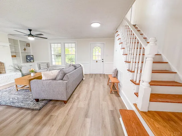 a living room with furniture and wooden floor