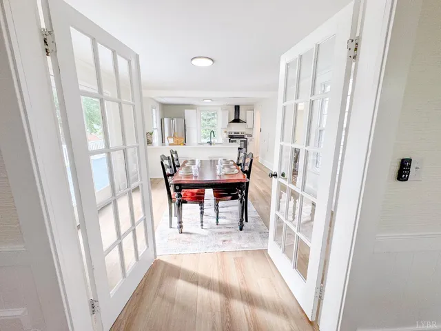 a view of front door with furniture and a window