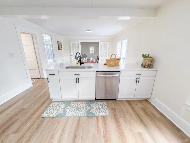 a view of a kitchen with wooden floor and electronic appliances