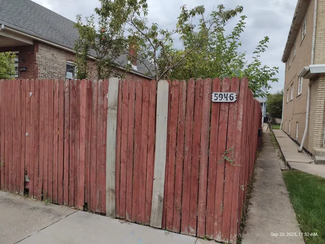 a view of a backyard with wooden fence