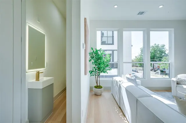 a large white kitchen with a large window