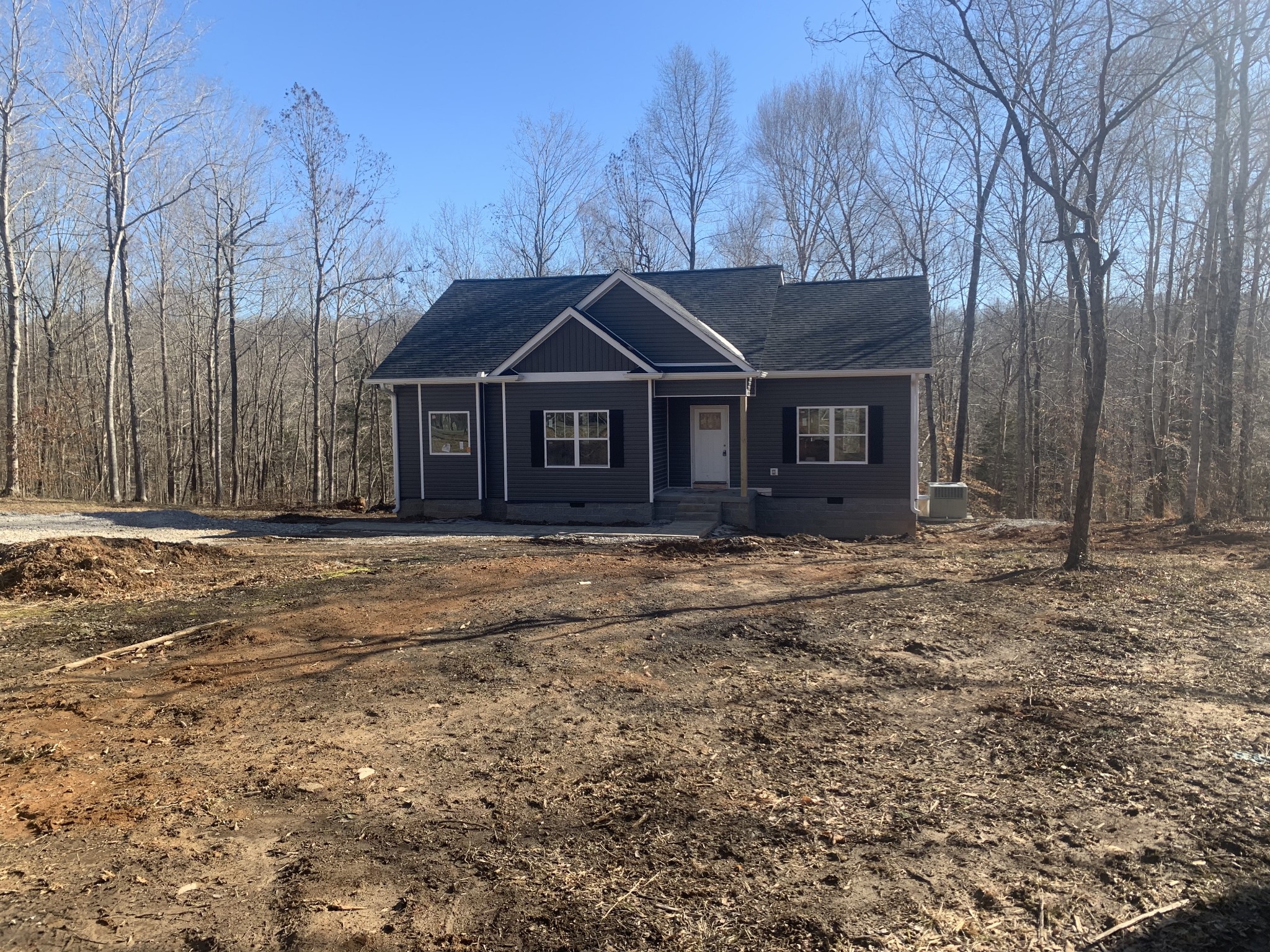276 A Murrell Road Dickson, TN 37055 - Photo 2 of 8 a front view of a house with a garden and trees