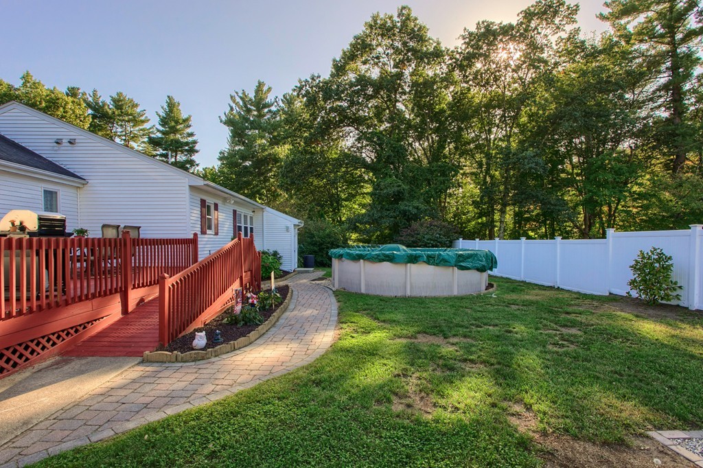 110 Walnut Road Tewksbury, MA 01876 - Photo 3 of 23 a view of a backyard with a small cabin and wooden fence