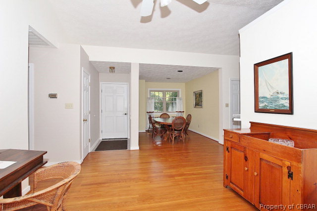 80 Deer Run Road Lancaster, VA 22503 - Photo 8 of 32 a living room with furniture a dining table and chairs with wooden floor