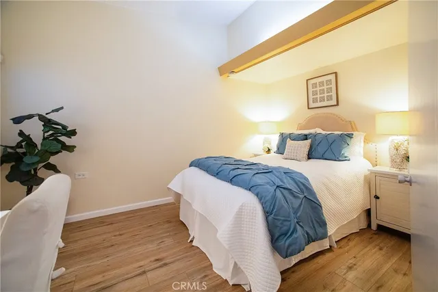 a bedroom with a bed and wooden floor
