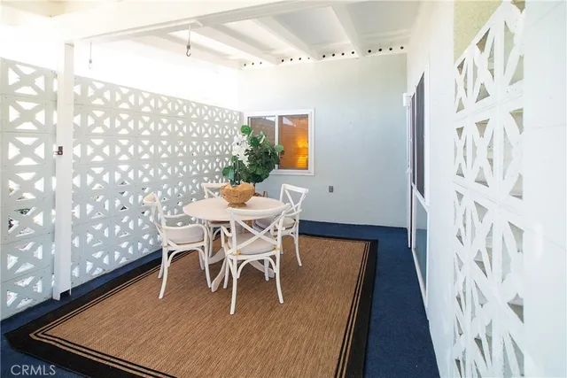 a dining room with stainless steel appliances a table and chairs