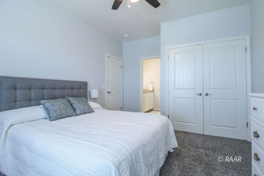 428 Scott Street Ridgecrest, CA 93555 - Photo 29 of 35 a bedroom with a bed and a chandelier