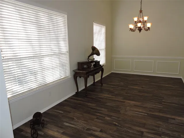 a room with wooden floor and a window