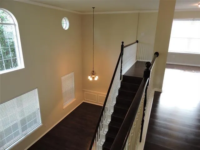 a view of entryway and hall with wooden floor