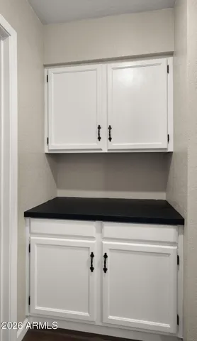 an empty room with a window and a ceiling fan