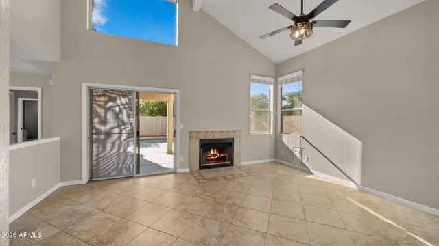 a view of an empty room with a fireplace and a window