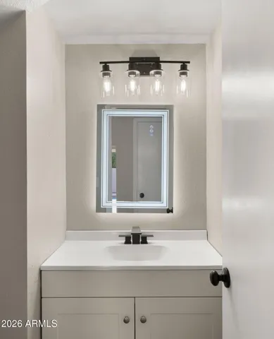 a view of an empty room with a fireplace and a window