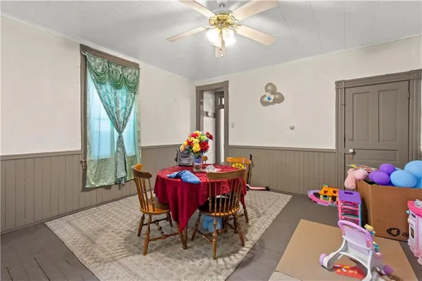 a kitchen with refrigerator a stove a sink dishwasher and wooden cabinets with wooden floor