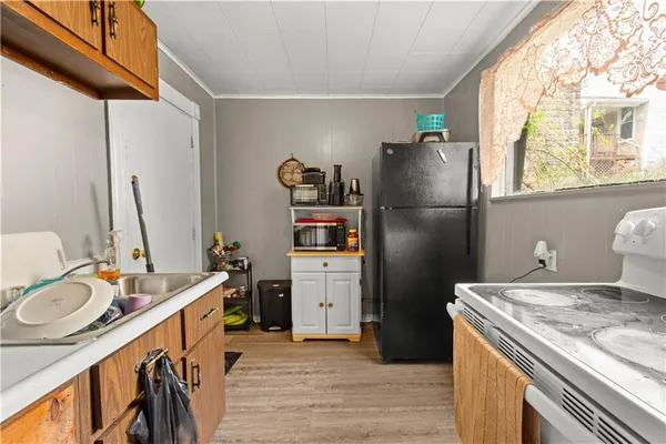 a view of kitchen with stainless steel appliances granite countertop cabinets and a dining table