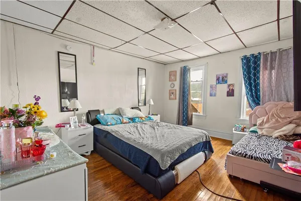 a bedroom with a bed and curtain