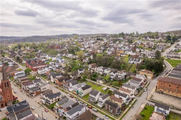 an aerial view of residential building with yard