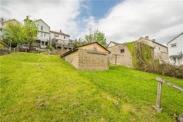 a view of a house with a yard and sitting area