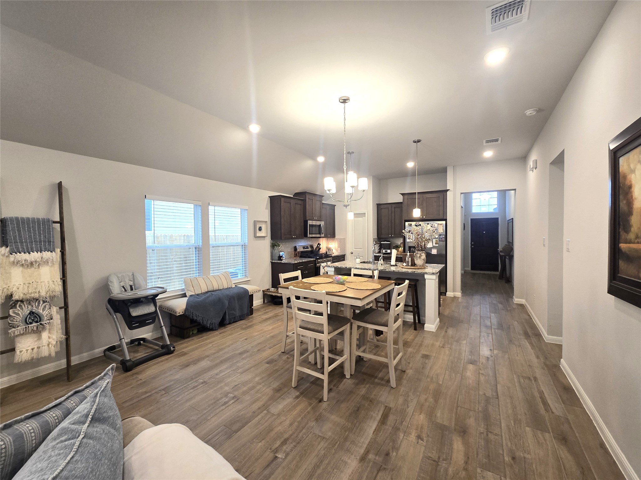 133 Boulder Ridge Trail Liberty Hill, TX 78642 - Photo 13 of 32 Dining room with dark wood-style floors and hanging lights