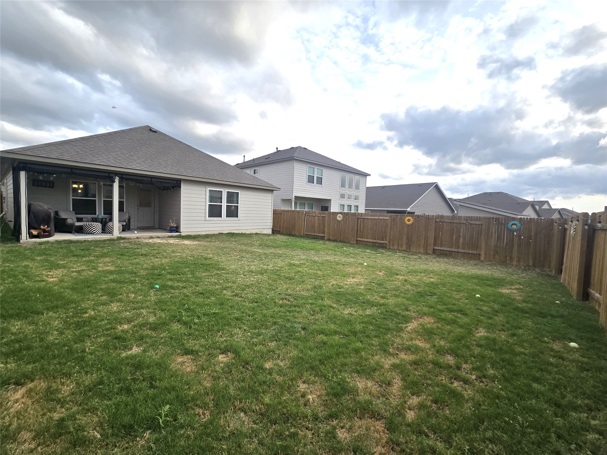 133 Boulder Ridge Trail Liberty Hill, TX 78642 - Photo 24 of 32 Back of house with a fenced backyard, a patio, and a shingled roof
