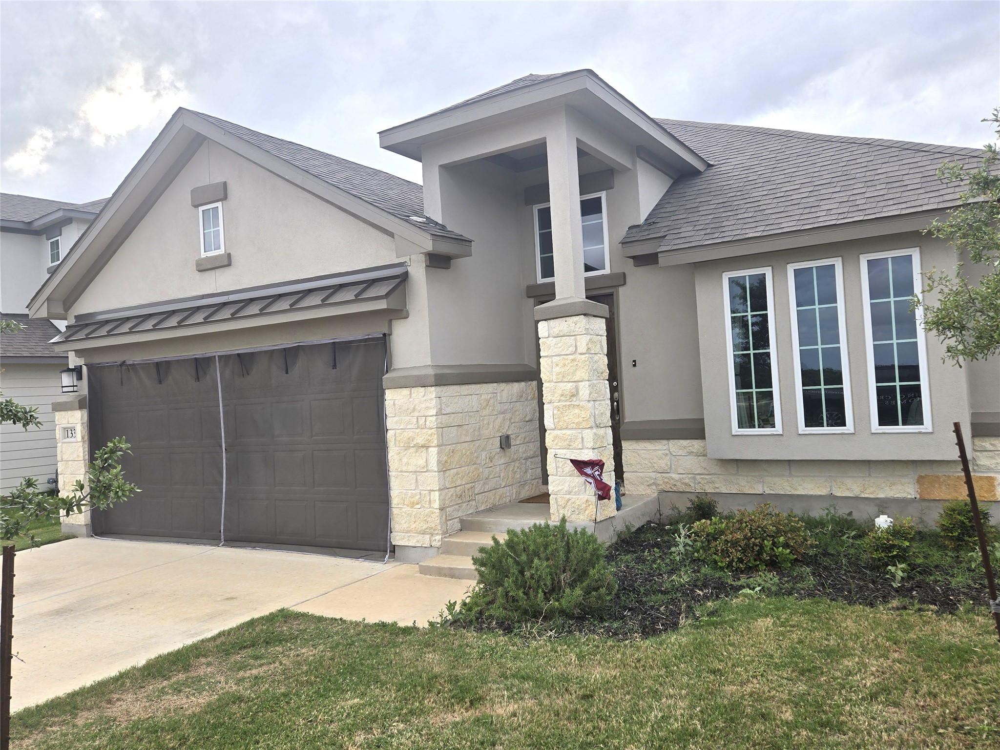 133 Boulder Ridge Trail Liberty Hill, TX 78642 - Photo 3 of 32 View of front facade with a shingled roof, stucco siding, and concrete driveway