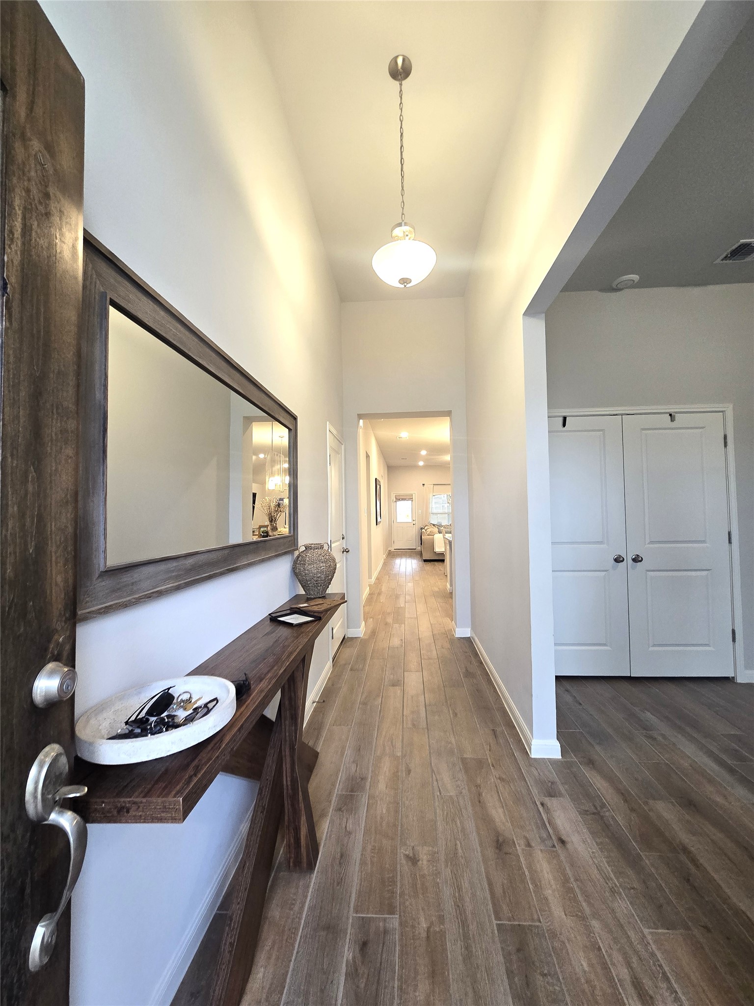 133 Boulder Ridge Trail Liberty Hill, TX 78642 - Photo 4 of 32 Hallway featuring dark wood finished floors and baseboards